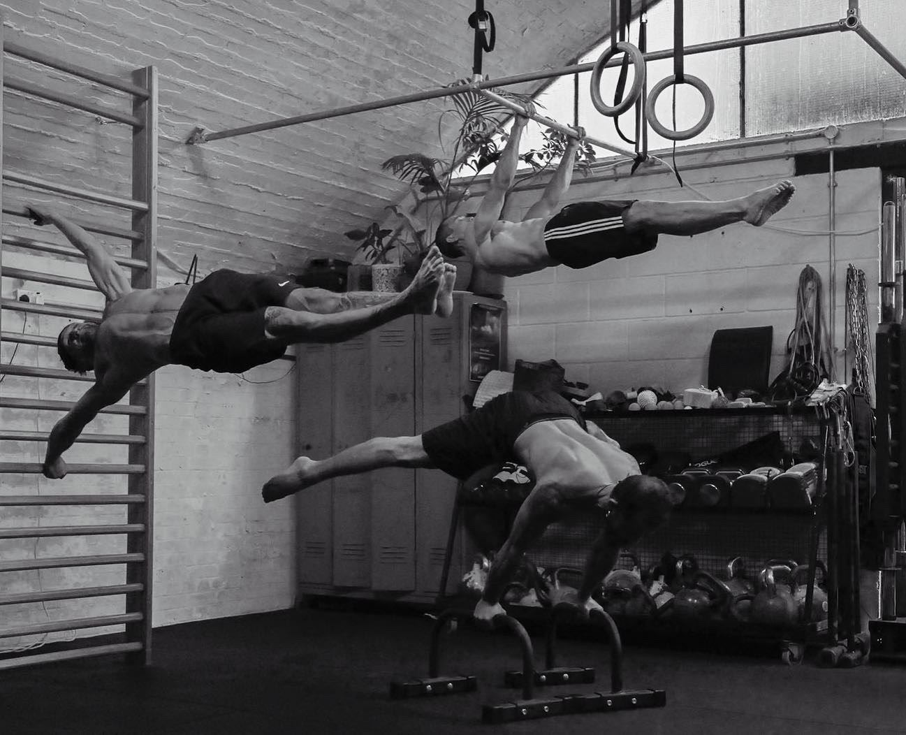 Idris and the coaching team demonstrating front lever, planche and lever holds at Evolve Athletic